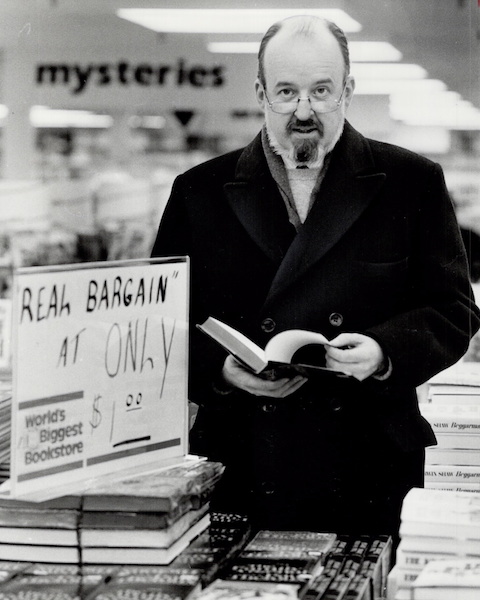 Robert Fulford browsing books in a bookstore
